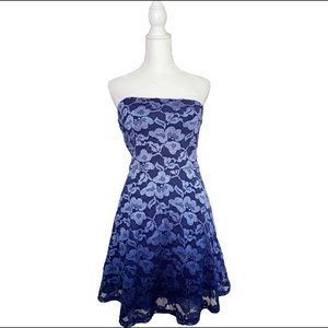 As U Wish juniors lace dress with belt. Strapless with elastic at top.